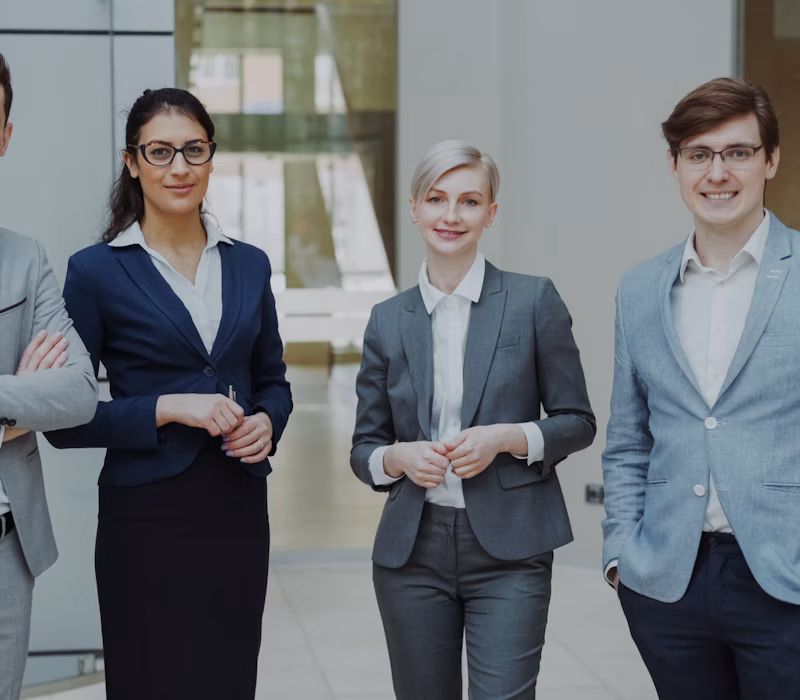 Four professionals in business attire